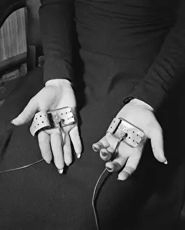 Displaying Prints: Pair of Hands Wearing Lie Detector Device