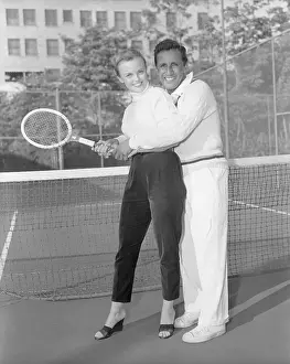 Pancho Segura Giving Tennis Lessons to Ann Baker