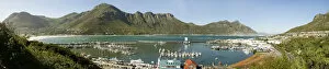 A panoramic picture of Hout Bay with Hout Bay Beach on the left and the marina and fishing harbour in the foreground