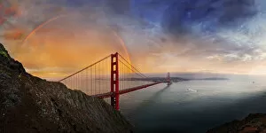 Golden Gate Suspension Bridge Gallery: Panoramic view of the Golden Gate Bridge with a rainbow at sunset and orange-glowing storm clouds