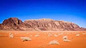Bedoin Prints: Panoramic view of Wadi Rum from a hilltop with clear blue sky background