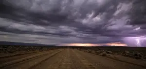 Karoo Prints: Panoramic views over the Tankwa Karoo Desert with dramatic thunderclouds in the sky