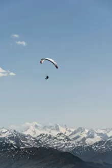 Images Dated 8th June 2014: Paraglider against a blue sky, snow-capped peaks of the Alps at the back