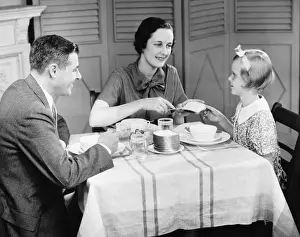 40 45 Years Prints: Parents with daughter (8-9) eating breakfast at home (B&W)