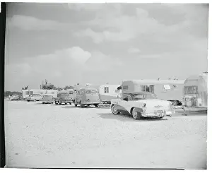Parking Area Filled with Trailers and Cars