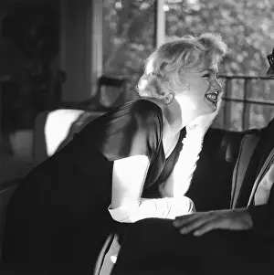 Prints of BEVERLY HILLS, CA - JULY 8: Actress Marilyn Monroe attends a party held in her honor wearing a black dress and white gloves at the Beverly Hills Hotel on July 8, 1958 in Beverly Hills, California Marilyn Monroe: The Iconic Muse Prints: Party For Marilyn At Beverly Hills Hotel