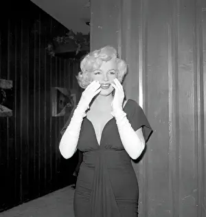 Prints of BEVERLY HILLS, CA - JULY 8: Actress Marilyn Monroe attends a party held in her honor wearing a black dress and white gloves at the Beverly Hills Hotel on July 8, 1958 in Beverly Hills, California Marilyn Monroe: The Iconic Muse Prints: Party For Marilyn At Beverly Hills Hotel