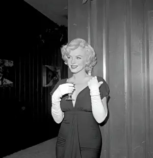 Prints of BEVERLY HILLS, CA - JULY 8: Actress Marilyn Monroe attends a party held in her honor wearing a black dress and white gloves at the Beverly Hills Hotel on July 8, 1958 in Beverly Hills, California Marilyn Monroe: The Iconic Muse Prints: Party For Marilyn At Beverly Hills Hotel