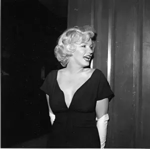 Prints of BEVERLY HILLS, CA - JULY 8: Actress Marilyn Monroe attends a party held in her honor wearing a black dress and white gloves at the Beverly Hills Hotel on July 8, 1958 in Beverly Hills, California Marilyn Monroe: The Iconic Muse Prints: Party For Marilyn At Beverly Hills Hotel