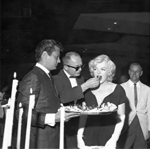 Prints of BEVERLY HILLS, CA - JULY 8: Actress Marilyn Monroe attends a party held in her honor wearing a black dress and white gloves at the Beverly Hills Hotel on July 8, 1958 in Beverly Hills, California Marilyn Monroe: The Iconic Muse Prints: Party For Marilyn At Beverly Hills Hotel
