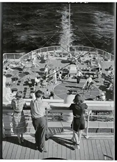 Passengers on Upper Deck Gazing out on Cruise Ship