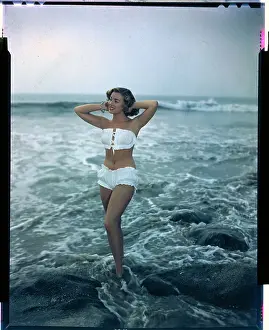 Pat Hall Standing in Water and Wearing White Bikini