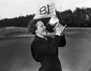Patty Berg Drinking from Golf Trophy