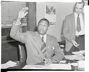 Paul Robeson Raising His Arm While Speaking to Press