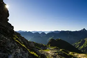 Oberstdorf Prints: Peaks of the Allgau Alps in steplike arrangement in the early morning with a sun star