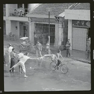 Laos Prints: Pedestrians Getting Wet on Wetting Holiday