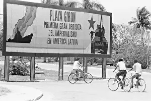 Pedestrians Passing Banner Depicting Cuban Pride