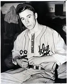 Pee Wee Reese Buttoning Dodger Uniform