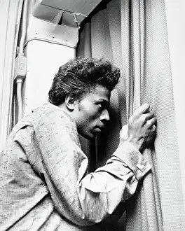 Prints of CIRCA 1957: Musician Little Richard peers out of a curtain in circa 1957. (Photo by Michael Ochs Archives/Getty Images) The Architect of Rock: Peeping Richard