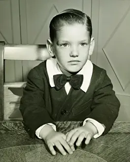 Introspection Prints: Pensive boy (4-5) posing at table, (B&W), portrait