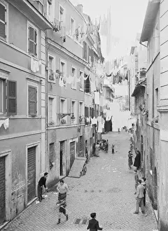 Clothesline Prints: People in Alley Standing Below Drying Laundry