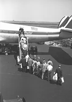 Waiting In Line Prints: People boarding on airplane, (rear view), (B&W), elevated view