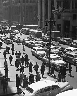 People on busy city street w / traffic