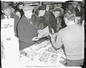 People Crowding Newsstand to Get Papers