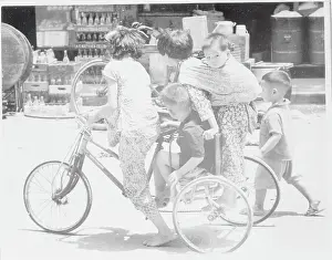 People Crowding on Tricycle
