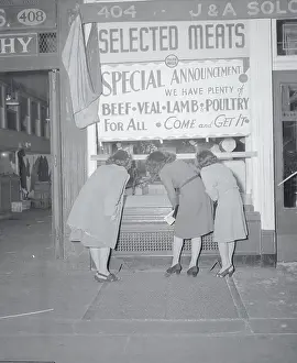 People Peering Through a Store Window