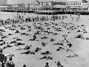 Holiday Maker Prints: People Performing Relaxing Exercises on Beach