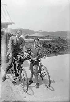 Two People Posing on Their Bicycles