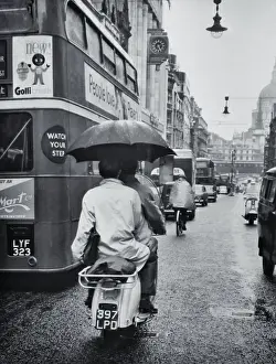 People Riding a Scooter