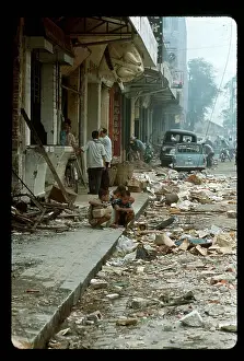 People Sifting Through Rubble in Street
