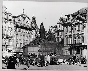 People Sit By Huss Memorial In Prague