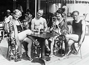 People Sitting Around Table Drinking