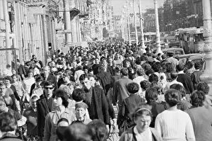 People Strolling Along a Street