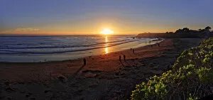 People at sunset at the Pacific beach of Cambria, California, United States