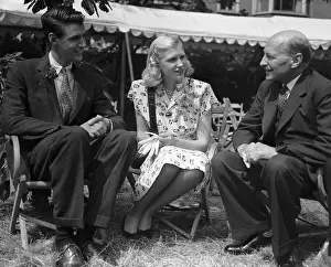 Prints of (Original Caption) 7/5/1947-London, England- Prime Minister Clement Atlee (left) is shown chatting with Miss Sharman Douglas and her brother, Peter, children of U.S. Ambassador and Mrs A Quiet Strength: A Leader Who Shaped Modern Britain: People Talking at Garden Party
