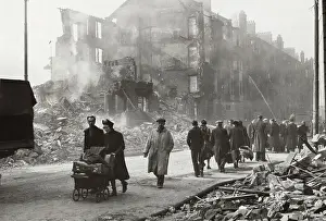 People Walking by Buildings Destroyed in Air Raids