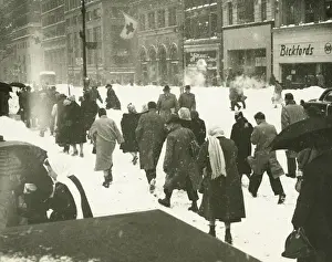City Location Prints: People walking on city street in blizzard, (Rear view)