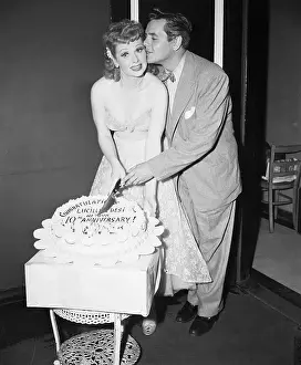 Performer Desi Arnaz Kissing Lucille Ball as They Prepare to Cut Cake