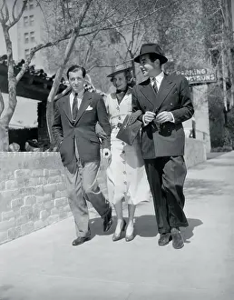 Prints of (Original Caption). Movie stars entertained at the White House are shown as luncheon guests of the President and Mrs. Roosevelt Behind the Laughter: Lucille Ball's Unseen Moments: Performer Lucille Ball Walking Arm in Arm With Broderick Crawford and a Friend