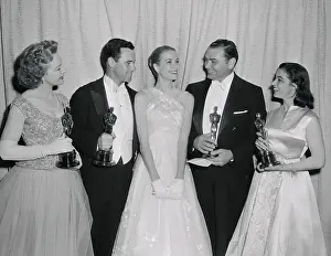 Performers Posing Together and Holding Oscars