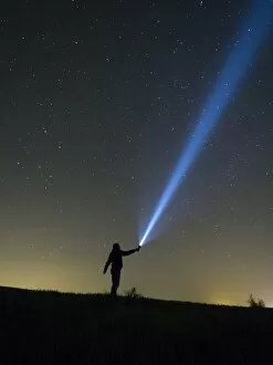 Images Dated 9th May 2015: Person lighting the sky with a flashlight