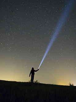 Images Dated 9th May 2015: Person lighting the sky with a flashlight