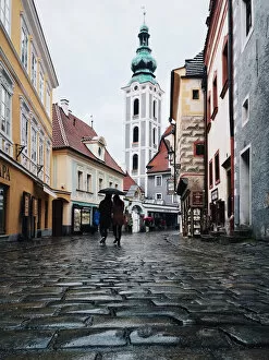 Images Dated 4th May 2016: Two persons with one umbrella wandering in the cobbled streets in the old town of Cesky Krumlov