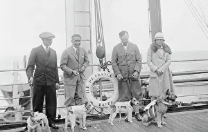 Leash Prints: Pet Owners with Dogs Wearing Life Preservers
