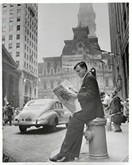 Philip Willkie Leaning on Hydrant Reading Newspaper