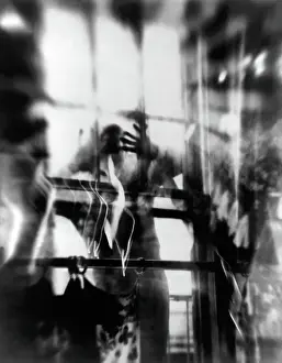 Prints of NEW YORK - 1957: An artistic photo montage (created in the darkroom by layering negatives together) of a man staring through a window, in 1957 in New York City, New York Portraits, Artworks, and Montages from a Visionary Photographer: Photo Montage of Man Staring Through Window in the 1950's